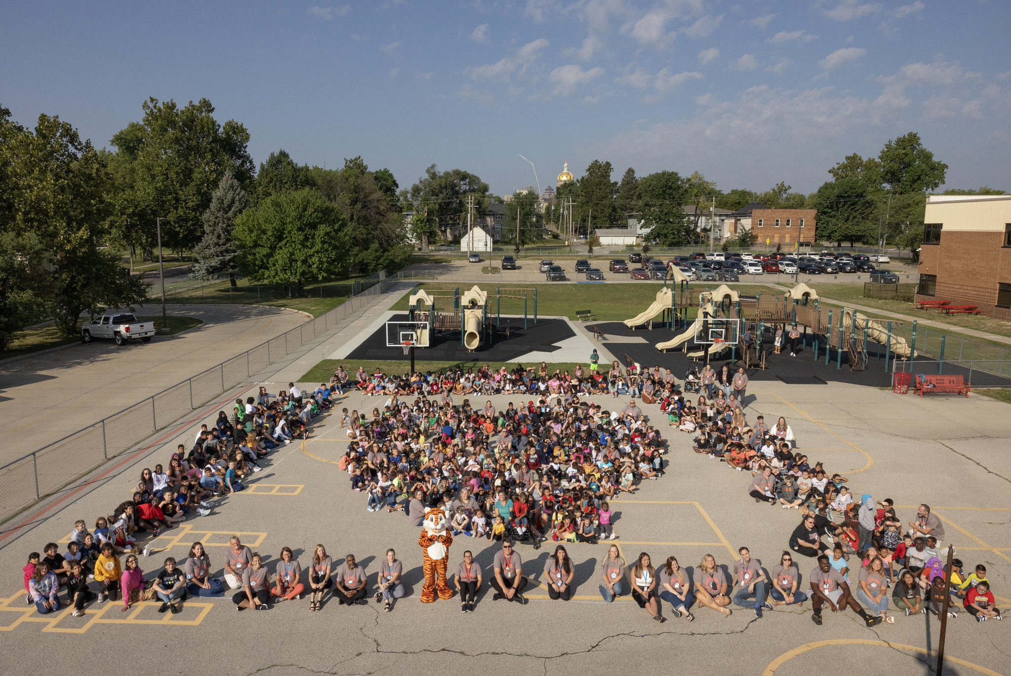 students sitting on the basketball courts arranged into a heart 